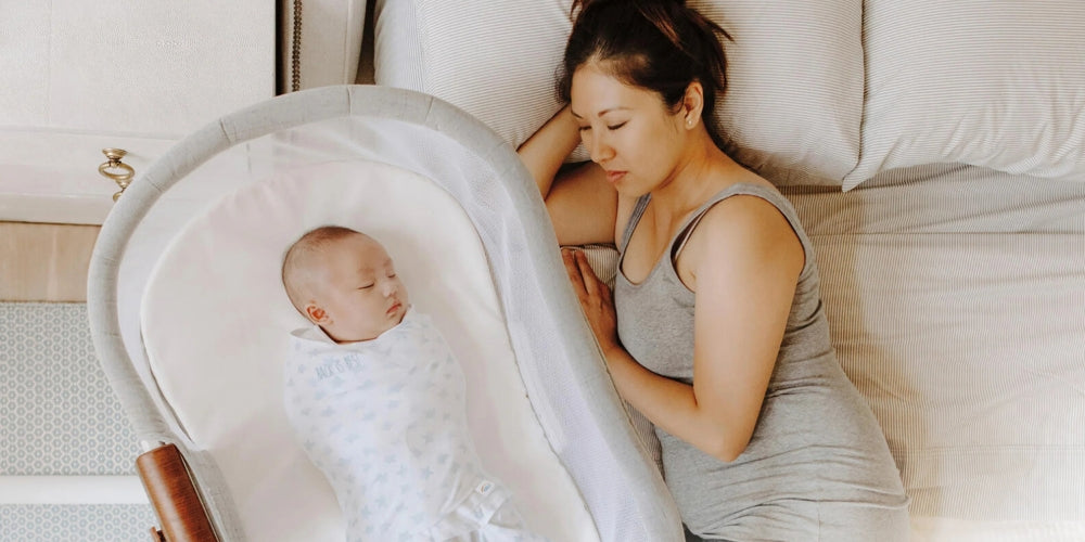 Portable bedside bassinet with mesh sides for safe sleep.