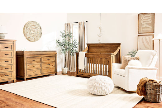 A charming baby's room with the Appleseed Rowan crib, dresser, and chair, offering a soothing environment for infants.
