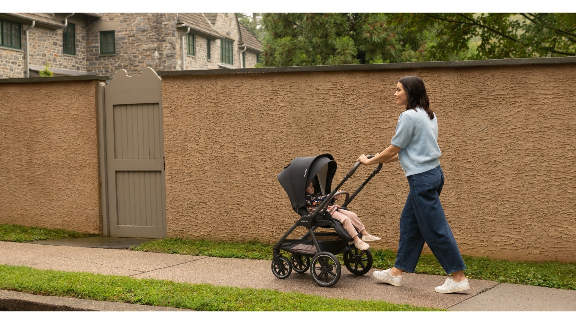 Mom walking toddler in Nuna TRIV or stroller with the seat in a parent facing orientation