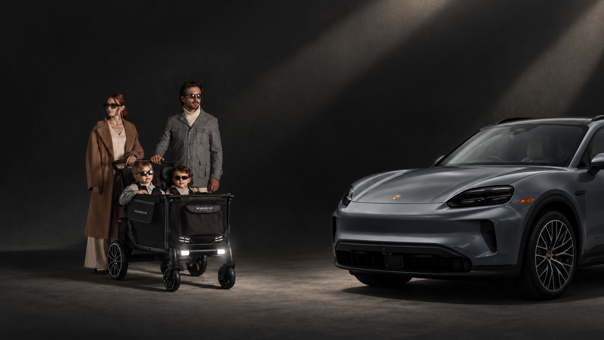 Family standing next to Porsche pushing Wonderfold x Porsche L4 Quad Stroller Wagon