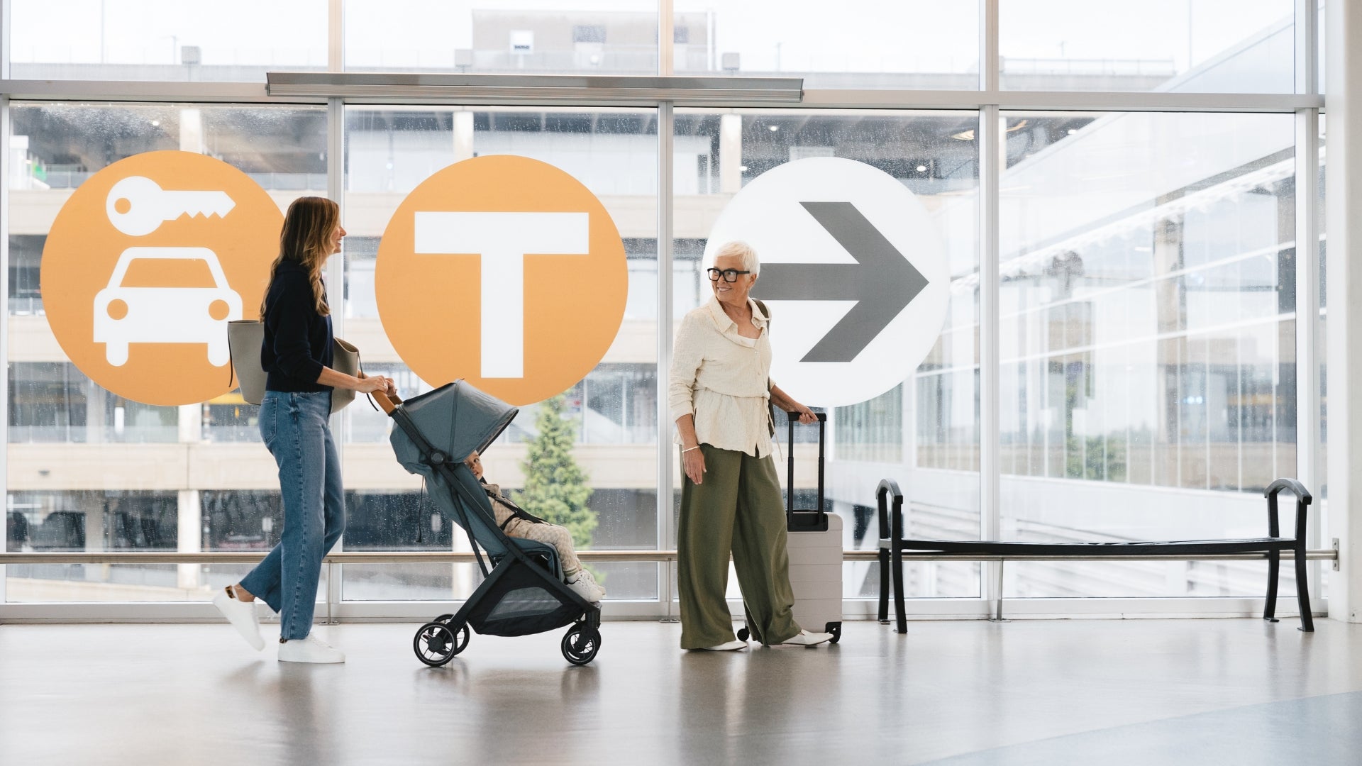 Mom pushing toddler in UPPAbaby Minu V3 through an airport