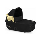 Black CYBEX MIOS 3 Jeremy Scott Wings Lux Carry Cot - Gold Wings Detail Angled View | Bambi Baby