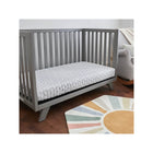 White Quilted Lullaby Earth Gentle Start Breathable Crib Mattress in Grey Crib - Side Angle | Bambi Baby