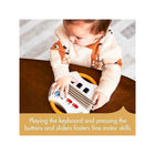 Toddler Pressing Buttons on Tiny Love Tiny Rockers Accordion - Fine Motor Skills Detail | Bambi Baby