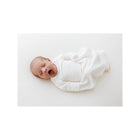 White Bamboo Swaddle Sleep Sack on Yawning Newborn - Overhead Lifestyle | Bambi Baby