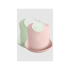 Powder Pink Powder Green BabyBjörn Silicone Baby Bibs 2-Pack - Angled View | Bambi Baby