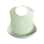 Powder Green BabyBjörn Soft Baby Bib with Catch Pocket - Angled View | Bambi Baby
