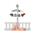 Multicolor Plush Dinosaur Musical Crib Mobile Above Baby in White Crib - Overhead View | Bambi Baby