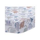 White Cotton Fitted Crib Sheet with Watercolor Dinosaur Print - Angled Top View | Bambi Baby
