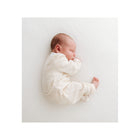 Cream Organic Cotton Baby Romper - Sleeping Newborn Side Profile | Bambi Baby