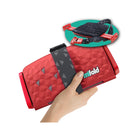Racing Red Mifold Comfort Grab-And-Go Compact Booster Seat - Folded View in Hand with Open Inset | Bambi Baby
