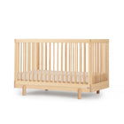 Natural Beechwood dadada Bliss 4-in-1 Convertible Crib - Angled Side View | Bambi Baby