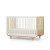 White Natural Wood dadada Jolly 3-in-1 Convertible Crib - Side View | Bambi Baby