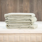 Forest Canopy Sage Organic Cotton Muslin Duvet Cover - Folded Stack on Naturepedic Mattress | Bambi Baby